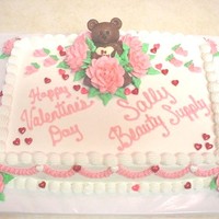 Valentines Bear this is a 9x13 cake, decorated with buttercream icing, and buttercream roses, a chocolate bears is snuggles in a cluster of roses, as candy...