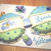 Baby Rattle Cake - Boy this baby rattle cake, is double layer 10" round cakes, with baby block in the middle of them, it is buttercream iced and all the...