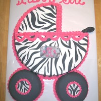 Zibra Babby Buggie this is a baby buggie made from a 16in round cake and (2) 6in round the 6in cakes are covered in black fondant and decorated with zibra and...