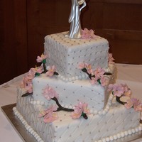 Cherry Blossoms This cake was decorated with fondant, fondant flowers, pearls and silver eatable beads.