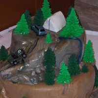 Mountain Camping This cake was decorated with fondant and royal icing trees. This cake is decorated