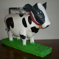 Sweet Besty Holstein cow cake: Body is lemon pound cake with buttercream and lemon curd filling: underbelly, legs and head are rice cereal covered with...