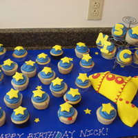Space Cupcakes Cupcakes decorated with stars. The rocket ship is made out of clay~ this was made by the birthday boy's mom!