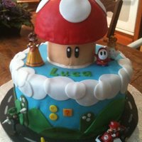 Super Mario Bros. Made this for a friend's son who wanted the Mario kart track. Made out of fondant, except for the character figures which were toys.