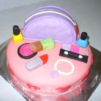 Makeup Cake birthday cake for my 6 year old who wanted a makeup party. Cake is covered in jello MMF, all decorations made out of MMF.TFL