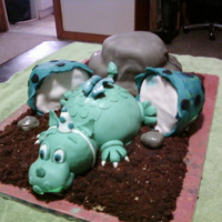 Baby Dragon Cake All MFF fondant. Each section of the cake is a different flavor of cake..mountain is pineapple cake with crushed pineapple filling, dragon...