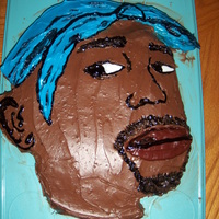 Tupac Cake This is a Tupac (the rapper) cake for my brother's birthday. Chocolate buttercream on white cake.