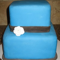 Simple Bright Blue Square Cake First attempt at fondanting normal-sized squares. 8" and 6" tiers. Brown accents, one single fondant rose. I really, really like...