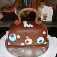 Purse Cake Made a 9x13 cake, cut in thirds and stacked to make this purse cake. It was a white cake with strawberry icing filling.