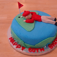 Golfer Birthday Cake The cake is devil's food with white icing and andees mints. Made the figurine out of marzipan and fondant.