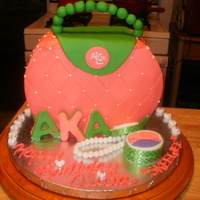 Aka Cake This is a marbel cake with pink fondant and edible pearls, compact, and AKA letters/