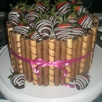 Valentine's Day Cake Chocolate cake, chocolate mousse and fresh strawberries for filling, and frosted with chocolate ganache. Bordered with pirouline cookies...