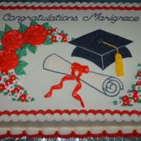 Graduation Cake Cake frosted and decorated in buttercream with royal icing drop flowers.
