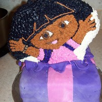 Dora Popping Out Of Cake Dora made with cake pan and held on top of MMF present with wooden dowels