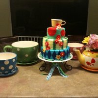 Alice In Wonderland Cake First tiered cake ever made. This was for a Mad Hatter Bunco party. The bottom layer is white cake with buttercream frosting and fondant...