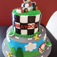 Mario Kart Mario Cake with Mario made from gum paste.
