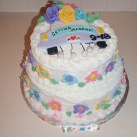 Bridal Shower Cake Butter cream with fondant & chocolate modeling clay accents. The car is made out of fondant and the flowers are white chocolate clay