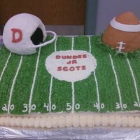 Football Cake Cake I made for a little league banquet...covered in buttercream. Helmet and football are rice krispies covered in fondant