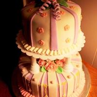 Two-Tiered Fondant Birthday Cake Lavender and pink with pink fondant roses, column supports