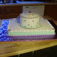 Teapot Cake all buttercream cake w/ fondant flowers and accents. 8" round cake w/ domed top on a half sheet cake.