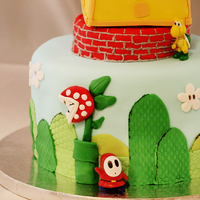 Super Mario Brothers Cake Super Mario Brothers Birthday cake. Cake was white butter cake with maple toffee crunch filling. Fondant and plastic figures used to...