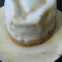Well-Worn Cowboy Hat My first attempt at a cowboy hat. Chocolate fudge cake with chocolate ganache, covered in MMF. The "trail dust" is cocoa powder...