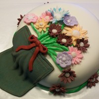 A Pocket Full Of Posies This is a fun cake I made for my anniversary. Chocolate cake filled with chocolate ganache and iced in buttercream, covered in MMF. Flowers...