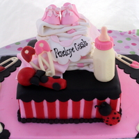 Welcome Baby Penelope! This was a super fun cake to do! Everything on the cake is edible; fondant stacked diapers, baby rattle, blankets, baby booties, ladybug as...