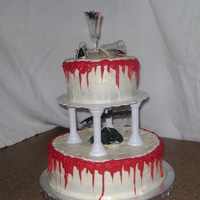 Halloween Wedding Cake Cream cheese icing on a chocolate cherry cake, chocolate filling, chocolate blood, fondant roses. There is a little plastic bat "...