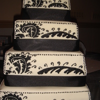 Black And White Square Cake 6in and 8in are chocolate cake with PB Mousse. 10in is vanilla/chocolate marble with cookies and cream filling and 12in is vanilla cake...