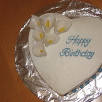 Calla Lillies- Birthday Cake This cake was a WASC cake with chocolate ganache filling. Iced with Vanilla buttercream with fondant calla lillies and a fondant ball...