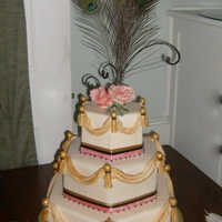 Peacock Wedding Cake 3 tier hexagon fondant cake with fondant swags & tassels painted with luster dust in gold and black. Sugar flowers and fondant covered...