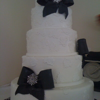 Black And White Wedding huge cake, with lace apliques and bows, and real broaches provided by bride.