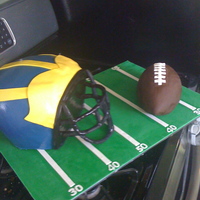 Michigan Football michigan helmet and football. helmet is all cake and the football in rice crispy treats. Face mask is a wire structure with fondant formed...