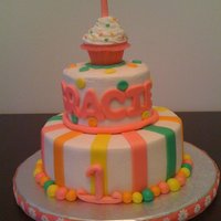 1St Birthday Bottom tier and cupcake is strawberry flavored. Middle layer is yellow cake. All buttercream with MMF accents. We used the cupcake as the...