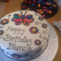 Britto Butterfly This was for my niece who was turning 19. Buttercream frosting with gumpaste decorations all hand painted. I used gel colors with vodka.