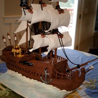 Pirate Ship Birthday Cake - Black Pearl Birthday cake themed after the "black pearl" ship. Made from cake, modeling chocolate and gumpaste. The only inedible product are...