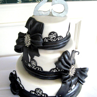 Black And White 25Th Anniversary Cake Cake made for a clients anniversary party. The bows are fondant and the brooches are non-edible :)