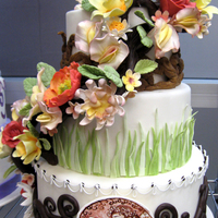 Gumpaste Flowers And Branches Wedding Cake Nature inspired wedding cake with modeling chocolate branches supporting the gumpaste flowers. Medallion was painted with vodka and petal...
