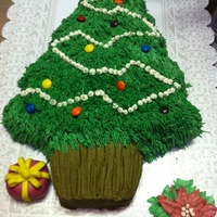 Christmas Tree buttercream using grass tip 233, tip 2 for garland, and fondant star. plain mm for lights. I used a tooth pic and made lines for the trunk...