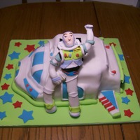 Buzz Lightyear And His Ship Based off of Tandori's incredible Buzz Lightyear cake. Carved out of yellow WASC. Buzz is made out of fondant. Airbrushed with a pearl...