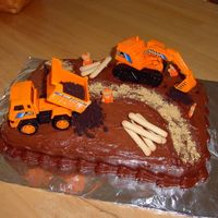 Construction Cake I used chocolate frosting on a 9x13 cake, construction trucks, crushed OREOS for dirt, Teddy Graham workers decorated with orange royal...
