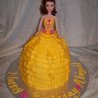 Belle Beauty and the Beast made from the doll cake pan with an 8" pan under it covered in yellow buttercream