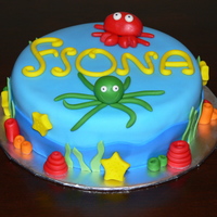 Under The Sea A baby shower cake, with an Under the Sea theme. It's an 8 inch pink lemonade cake, with raspberry buttercream and white chocolate...