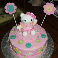 Hello Kitty Cake This was my first fondant cake it was for my daughter first birthday is cover in fondant the flowers and other accents made of gum paste...