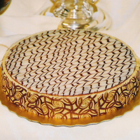 Cheesecake W/ White Chocolate This is a cheesecake covered with white chocolate ganache. The sides are covered with a hazelnut joconde that was baked on a chocolate...