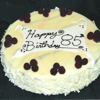 White Chocolate And Raspberry Dark chocolate cake, filled with CC frosting and fresh raspberries. Covered with white and colored chocolate ganache. Sides are white...