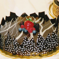 Chocolate On Chocolate Killer Chocolate cake, filled with BC, covered with dark chocolate ganache, and topped with fresh berries. Sides are dark chocolate shards...