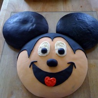 Mickey Mouse My first fondant cake! Spice cake covered in fondant. I mixed the black into the fondant myself. Never again!!