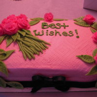 Bridal Shower Cake With Roses The shower theme was pink, green and black. I made the roses and ribbon out of plastic chocolate. The frosting is buttercream